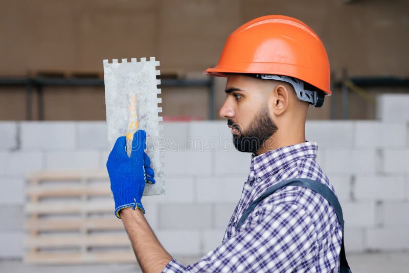 The Process of Bricklaying. Mason Hands Installing Aerated Concrete