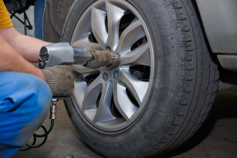 The Process of Changing Tires on a Car before the Season Stock Image