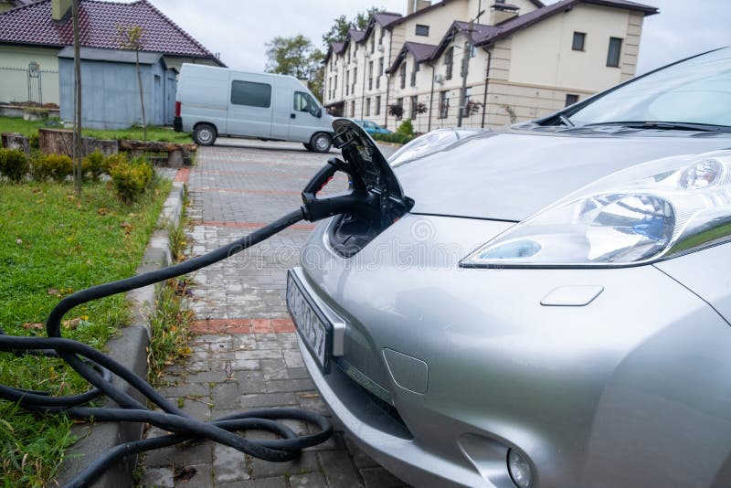 The Process of Charging an Electric Car on Public Charging Stock Image