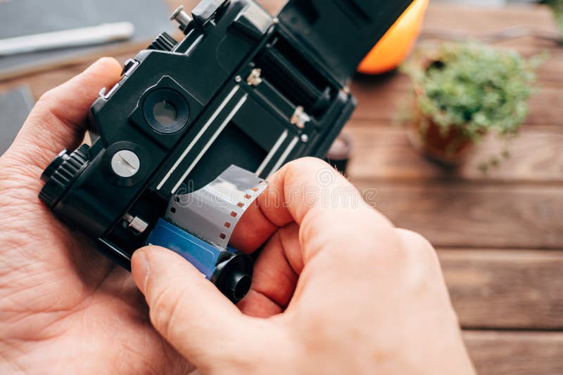 The Process of Charging of Film Reel into the Photo Camera. Stock Image