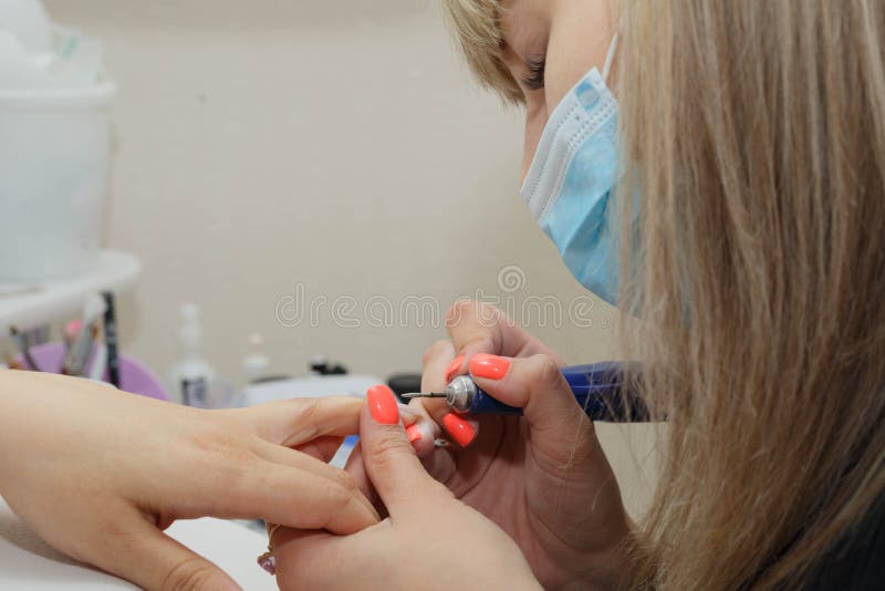The process of cleaning the nail from the old coating, alignment and giving it the desired shape stock image The process of cleaning the nail from the old coating, alignment and giving it the desired shape stock image