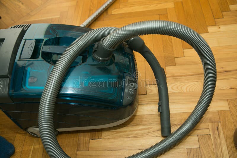 The Process of Cleaning a Room with a Vacuum Cleaner with an Aquafilter. Hands of a Man