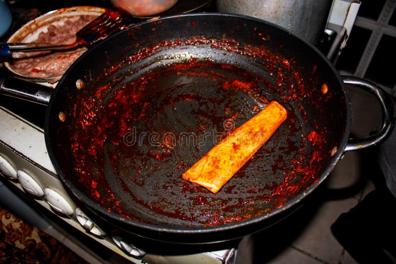 Process of Cooking Mexican Traditional Dish Enchiladas with Cheese and