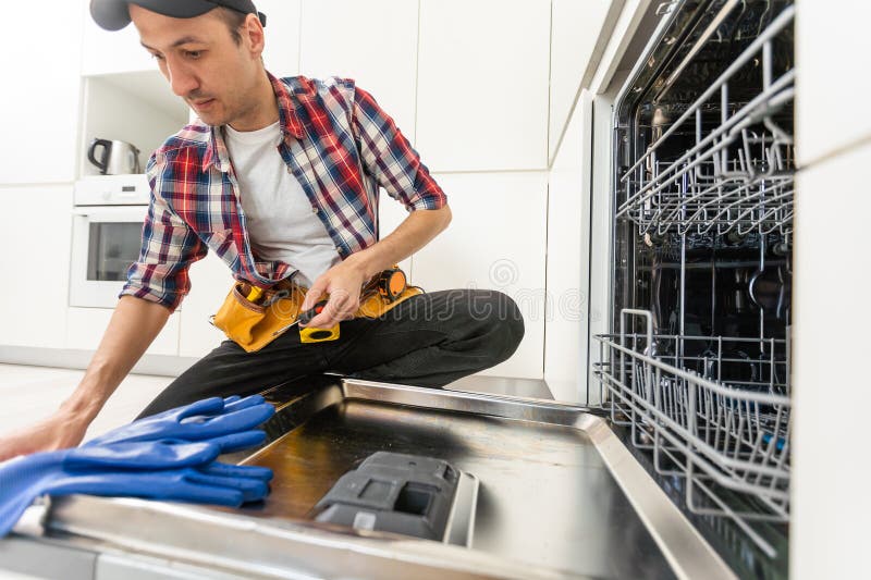 Process of Dishwashing Machine Installation. Young African Service Man