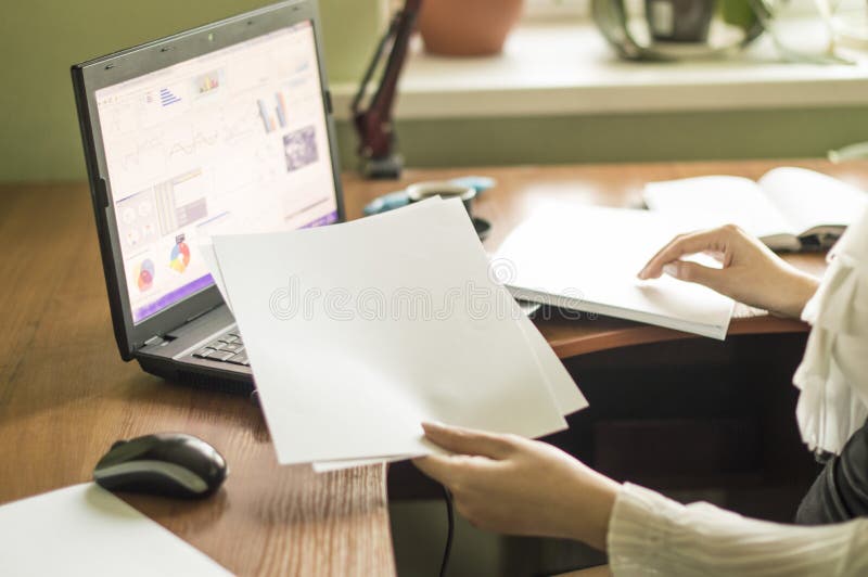 The process of with a laptop and documents on a Office desk