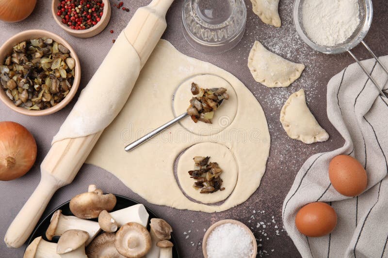Process of Making Dumplings (varenyky) with Mushrooms. Raw Dough and Ingredients on Grey Table
