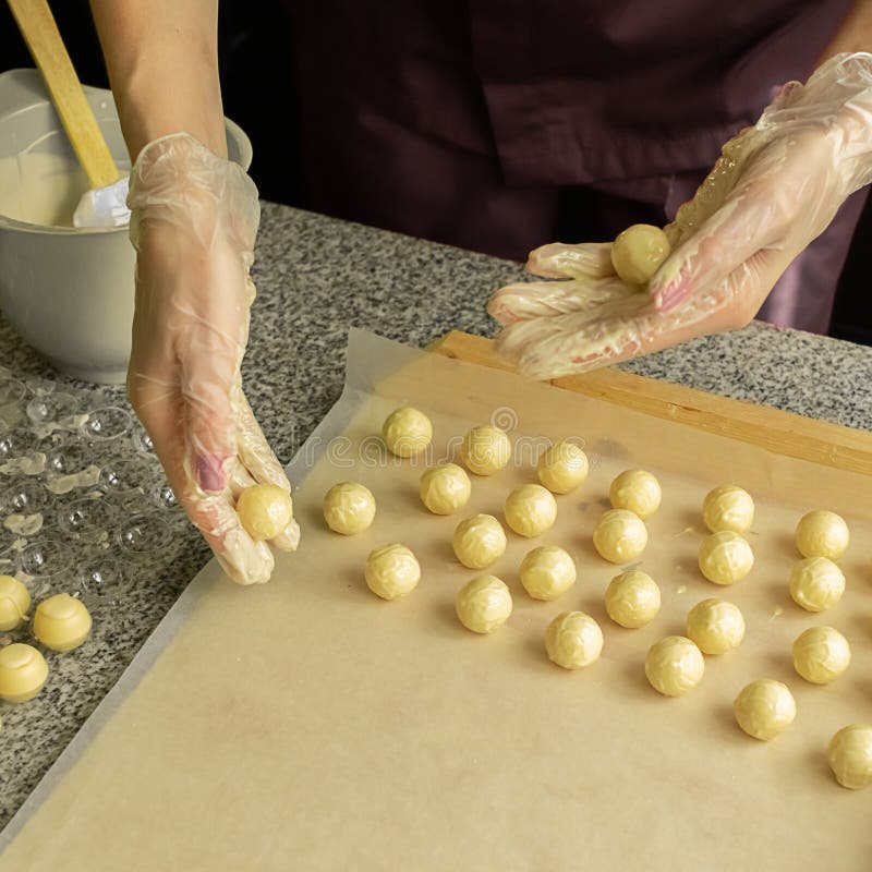 The Process of Making Handmade Chocolates. Round Chocolate Candies in