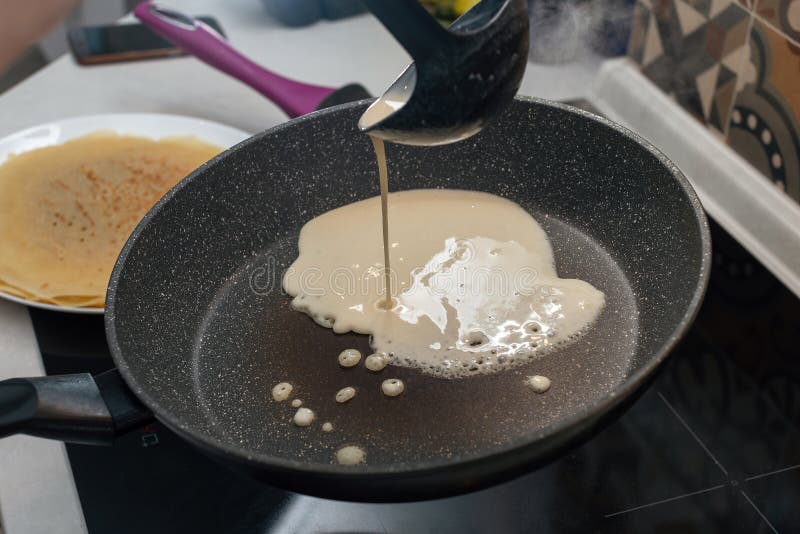 The Process of Making Pancakes on an Electric Stove Stock Photo Image