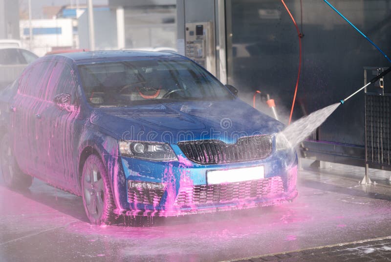 Process of Man Washing His Car in a Selfservice Car Wash Station Stock