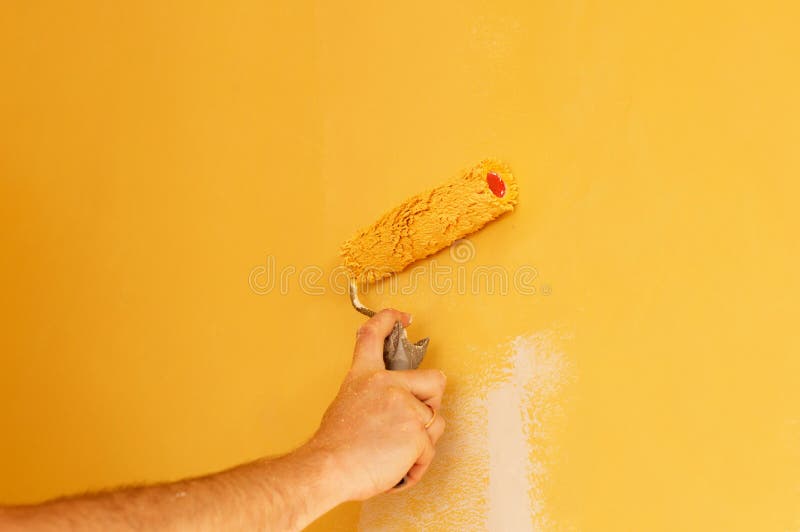 The Process of Painting the Walls in Yellow Color Stock Photo Image