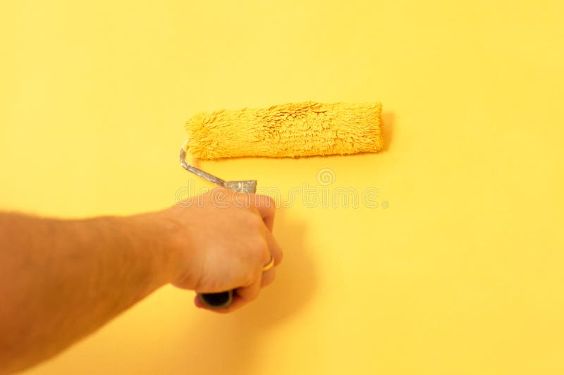 The Process of Painting the Walls in Yellow Color Stock Photo Image