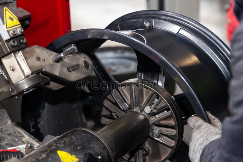 The Process of Repairing an Automobile Wheel Using a Special Press on a