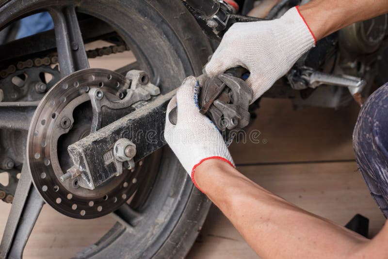 The Process of Replacing Brake Pads on a Motorcycle Stock Photo Image