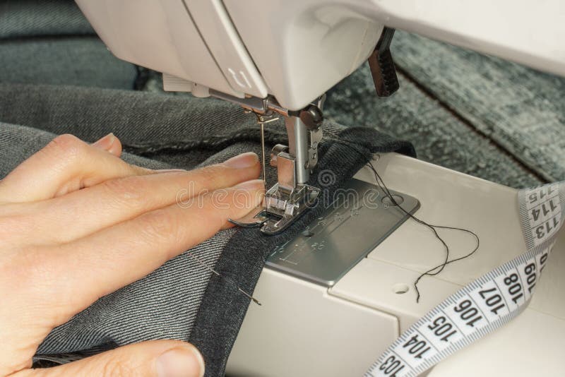 Process of Shortening Jeans Pants on a Sewing Machine Stock Photo