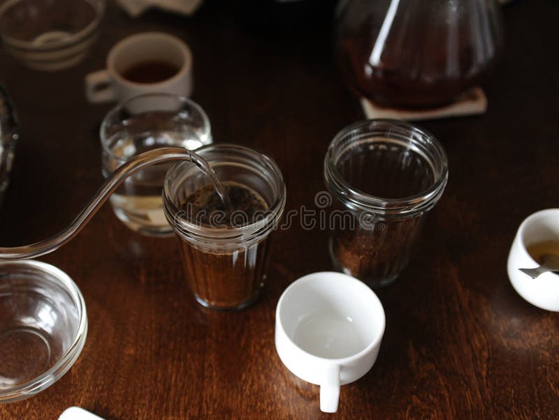 The Process of Tasting Cupping. Coffee is Brewed in Glass Cups Stock
