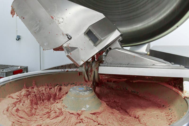 Process of work big steel grinder in production of sausage stock photography