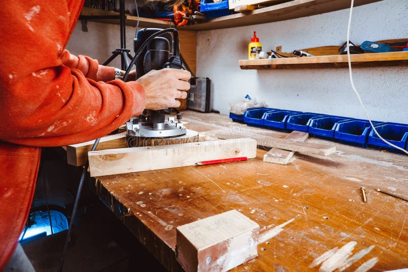 Processing of a furniture part by a machine for polishing a tree. the grinding machine on a board, selective focus. stock photo