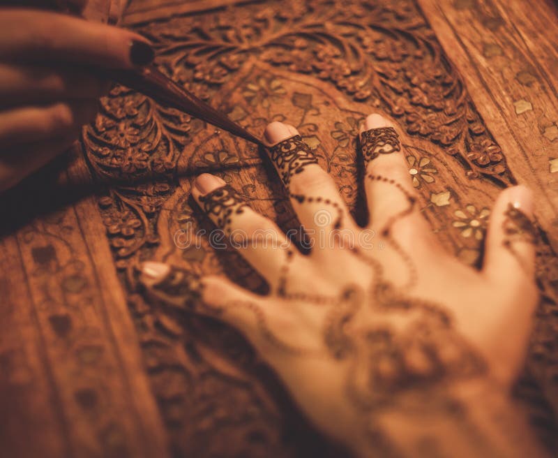 Drawing process of henna menhdi ornament on woman's hand. Drawing process of henna menhdi ornament on woman's hand