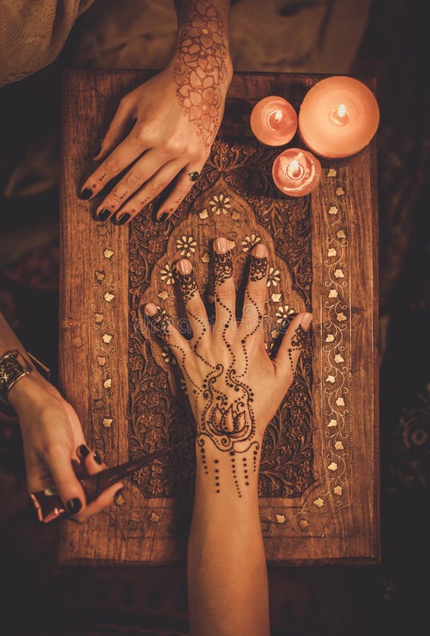 Drawing process of henna menhdi ornament on woman's hand. Drawing process of henna menhdi ornament on woman's hand