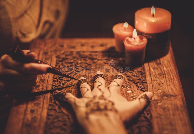 Drawing process of henna menhdi ornament on woman's hand. Drawing process of henna menhdi ornament on woman's hand