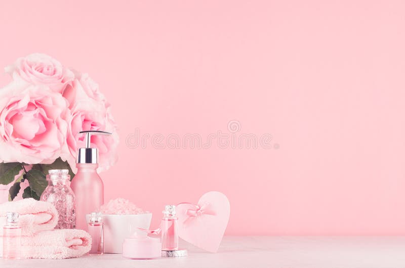 Different skin care products with romantic roses bouquet, decorative heart on girlish elegant pink pastel background with copy space. Different skin care products with romantic roses bouquet, decorative heart on girlish elegant pink pastel background with copy space