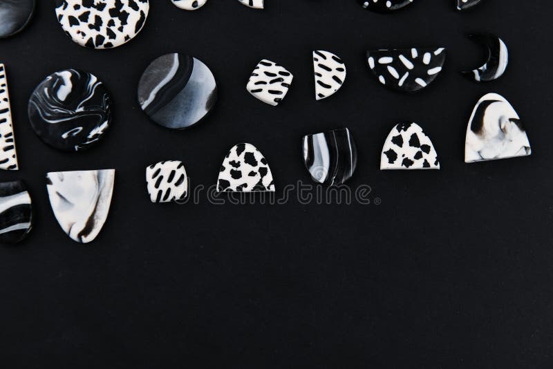 A Product From Polymer Clay. Black And White Polymer Clay. Hand Sculpting,  Product For Earrings On A Black Background. View From Above. Black And  White Jewelry Earrings. Handmade Polymer Clay Jewelry. Stock