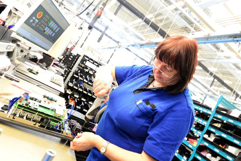 Production and assembly of microelectronics in a hi-tech factory stock image Production and assembly of microelectronics in a hi-tech factory stock image