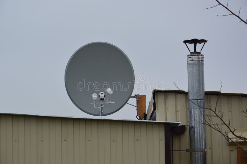 Production of a Bracket for Mounting a Satellite Dish on the Roof of a Building Stock Image