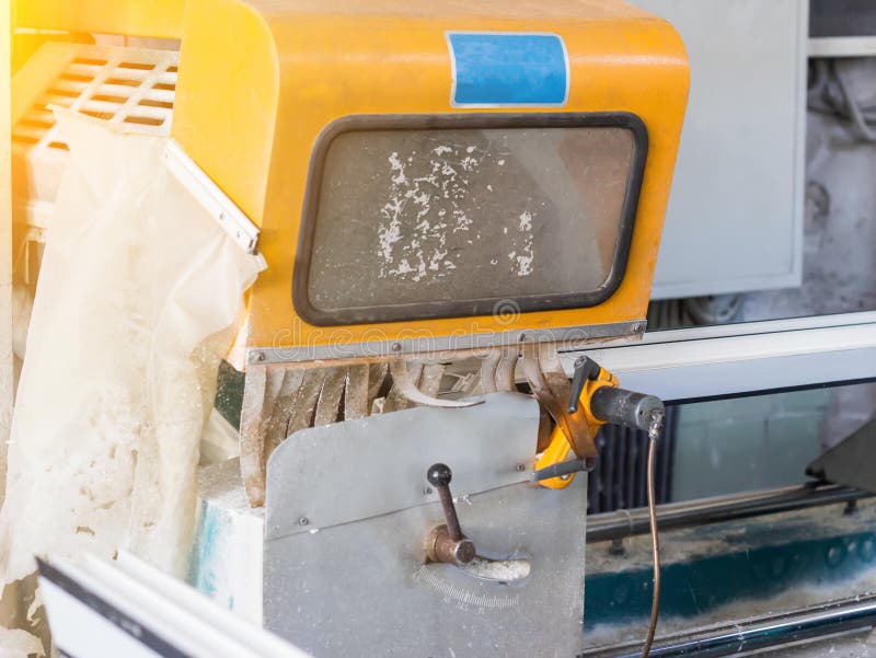 Production of PVC windows, a section of PVC plastic profile on the frame machine, machine-tool royalty free stock photography