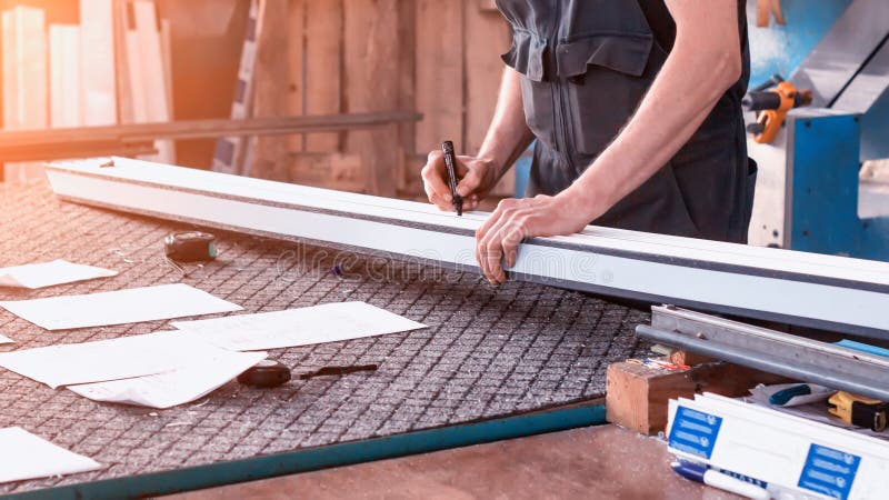 Production windows pvc, a man writes on the plastic profile dimensions, close-up, pvc, write a marker, arm stock photo