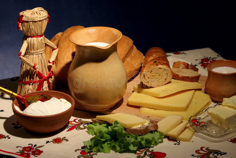 Still-life about rural supper with cheese, milk, bread, butter and sour cream. Still-life about rural supper with cheese, milk, bread, butter and sour cream.