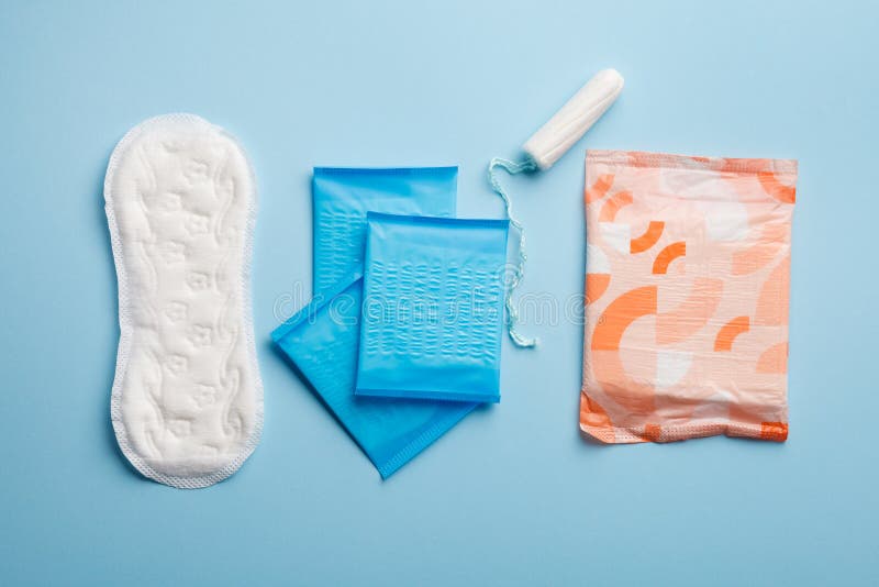 menstruation products, woman intimate hygiene, sanitary pads and tampon on blue. menstruation products, woman intimate hygiene, sanitary pads and tampon on blue