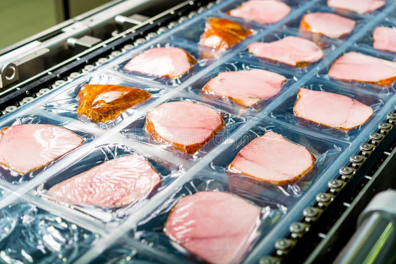 Several chunks of raw meat being processed packaged and shipped. Several chunks of raw meat being processed packaged and shipped