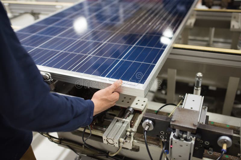 Production of solar panels, man working in factory. Production of solar panels, man working in factory