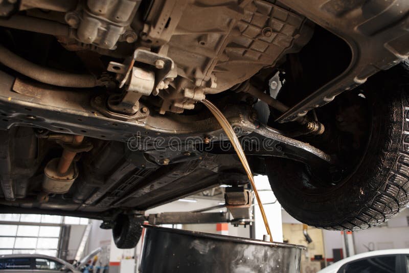 Profecional car mechanic changing motor oil in automobile engine at maintenance repair service station in a car workshop royalty free stock images Profecional car mechanic changing motor oil in automobile engine at maintenance repair service station in a car workshop royalty free stock images