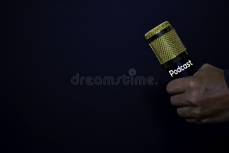 Profesional Microphone on hands isolated black background. Podcast Concept stock photo