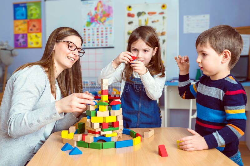 Preschool Teacher with Kid at Kindergarten. Mother with children at home. Early education. Preschool Teacher with Kid at Kindergarten. Mother with children at home. Early education.