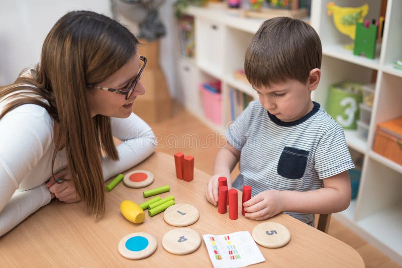 Preschool Teacher with Kid at Kindergarten. Early education. Preschool Teacher with Kid at Kindergarten. Early education.