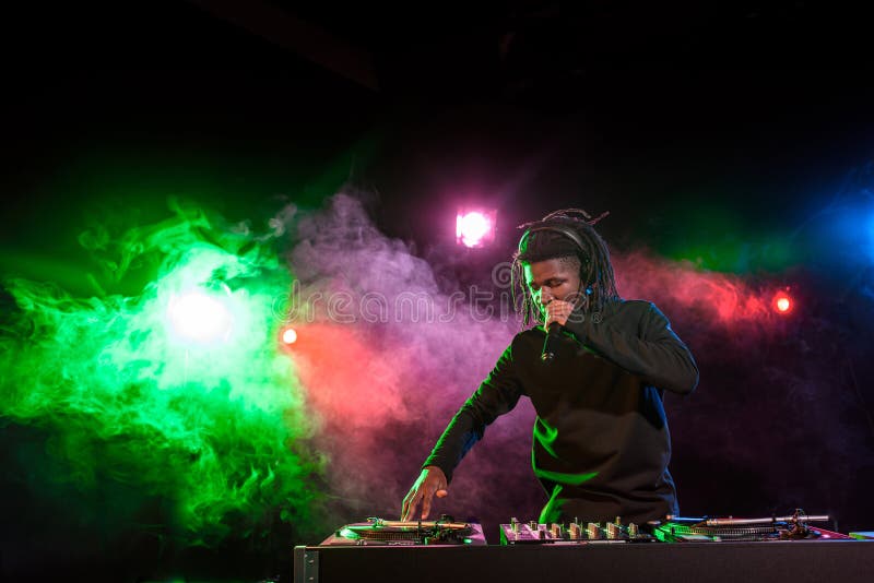 professional african american DJ in headphones with sound mixer royalty free stock photo professional african american DJ in headphones with sound mixer royalty free stock photo