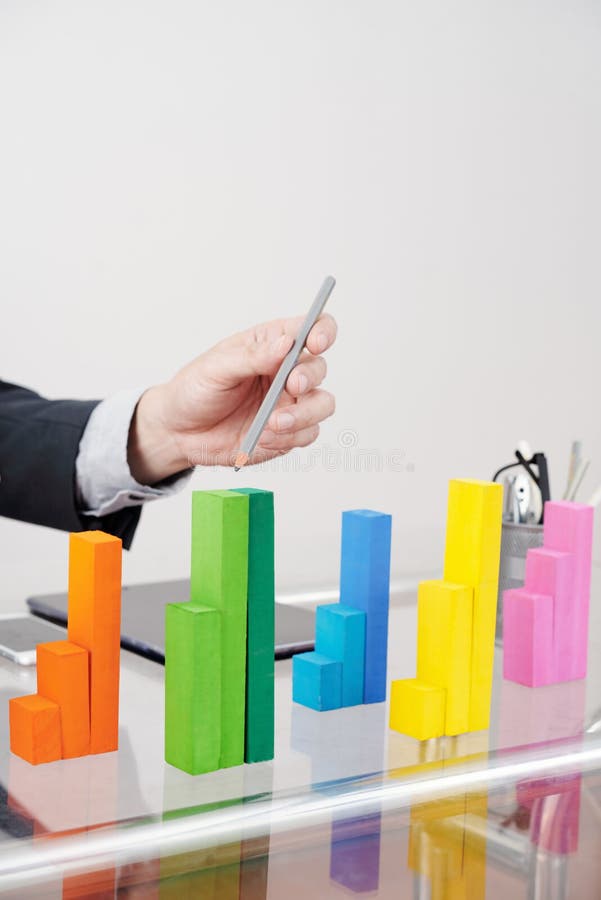 Professional analyst pointing at wooden blocks chart stock photos