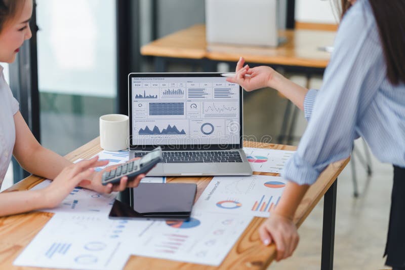 Professional analyzing financial data graphs, charts on laptop display at a modern workspace. Financial analysis or royalty free stock photos