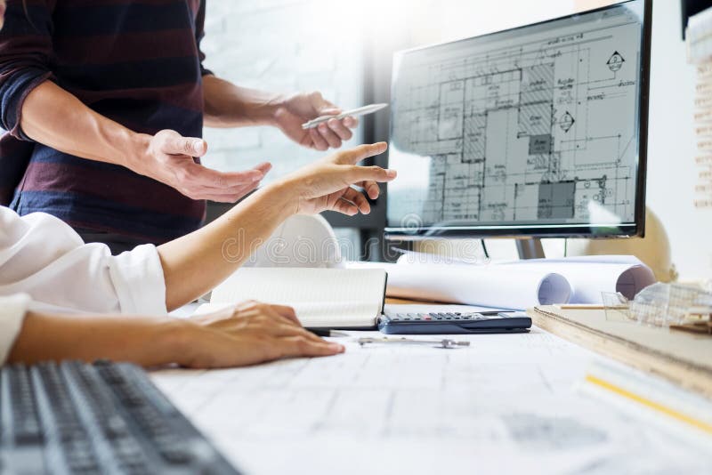 Professional architect designer structural engineer team colleagues working office looking computer discussing building plan royalty free stock images