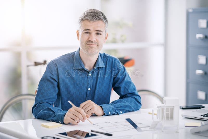 Professional Architect Sitting At Office Desk And Working He Is