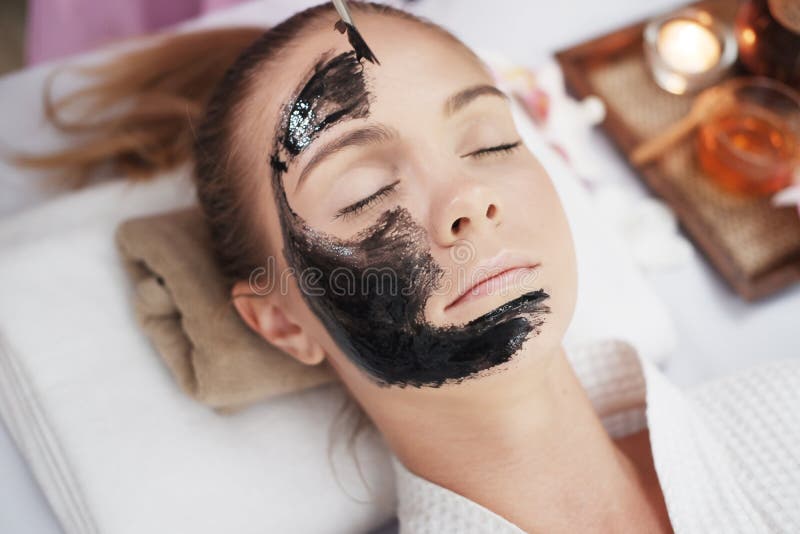 Professional Asian Thai Massage Therapist Woman Is Applying Black Facial Mask For Young