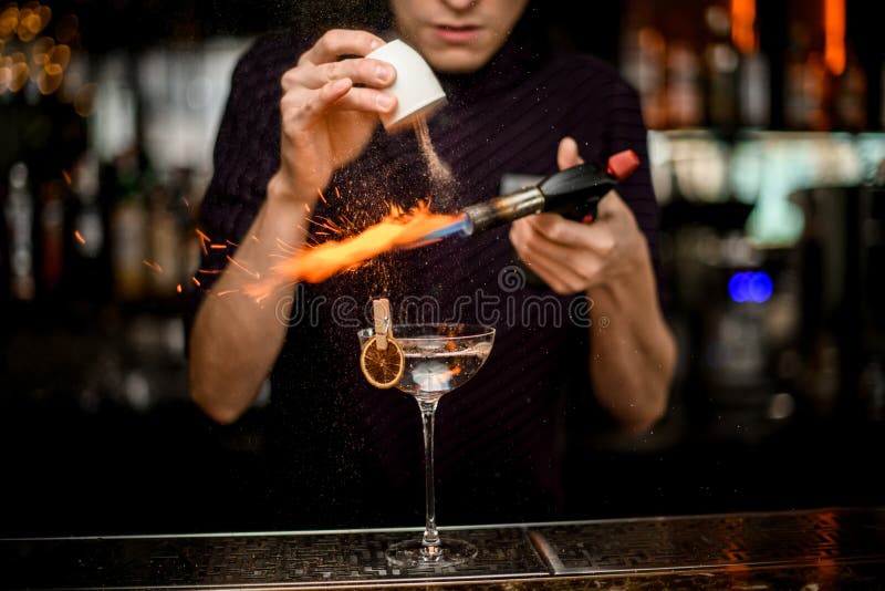 Professional Bartender Adding To an Alcoholic Cocktail in the Glass