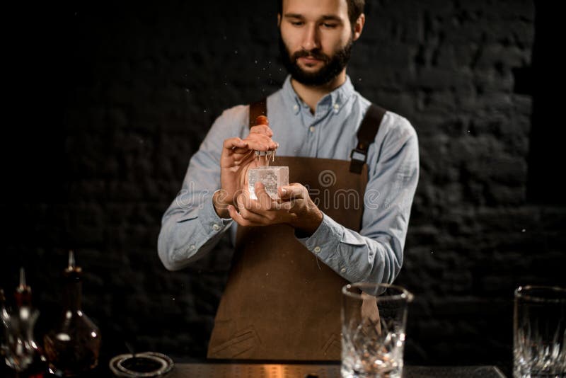 Professional Bartender Cutting Ice with a Special Fork in Hands in the Bar Stock Photo Image