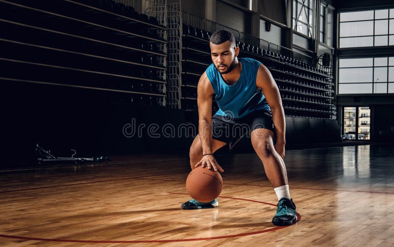 Professional basketball player in an action in basketball field.