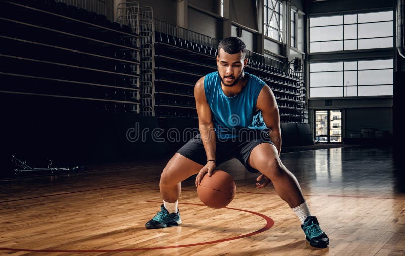 Professional basketball player in an action in basketball field.