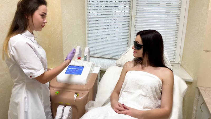 Professional beautician working. Close-up procedure of removing hairs on hand. Laser hair removal on a diode laser