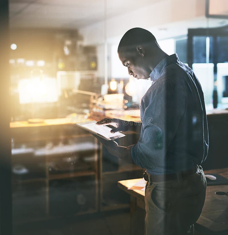 Professional black man, tablet and night business, information technology and software update. Male programmer work late stock images